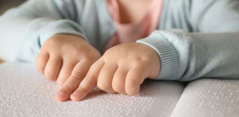 Barnehender som leser punktskrift